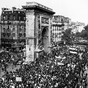 Workers participating in the general strike, pass the Porte Saint Denis while marching down Boulevard Saint Denis on the Right Bank in Paris, 24 May 1968