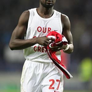 Arsenal defender Emmanuel Eboue throws his shirt to
