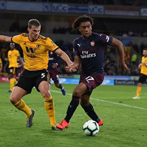 Arsenal's Alex Iwobi Fends Off Wolves Ryan Bennett During Intense Premier League Clash (Wolverhampton Wanderers vs Arsenal, 2018-19)