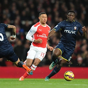 Arsenal's Alex Oxlade-Chamberlain Outmaneuvers Southampton's Jose Fonte and Victor Wanyama