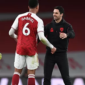 Arsenal's Mikel Arteta and Gabriel Magalhaes Celebrate Victory over Tottenham Hotspur
