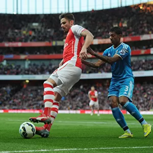 Arsenal's Olivier Giroud Battles Past Sunderland's Patrick van Aanholt in Intense Premier League Showdown