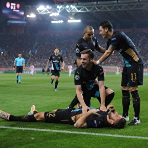 Arsenal's Stars: Giroud, Ramsey, Ozil, and Walcott Celebrate Goals Against Olympiacos in the UEFA Champions League