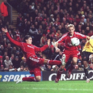 Jermie Aliadiere (Arsenal) shoots under pressure from Sami Hyypia