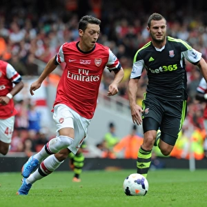 Mesut Ozil (Arsenal) Erik Pieters (Stoke). Arsenal 3: 1 Stoke City. Barclays Premier League