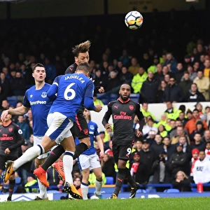 Mesut Ozil Scores Under Pressure: A Intense Moment from Everton vs Arsenal, Premier League 2017-18 - Ozil's Goal Amidst Jagielka's Challenge
