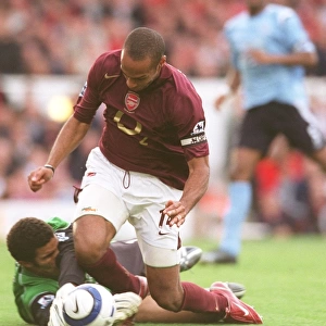 Thierry Henry (Arsenal) is tripped by David James (Man City) for the Arsenal penalty