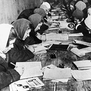 A basic literacy class given at the club of the krasny bogatyr works (factory) in moscow, 1932