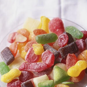 Bowl of colourful gummy sweets, close up