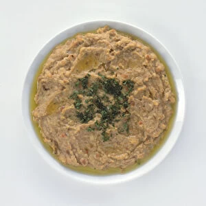 Bowl of Fuul, a traditional Egyptian dish of pureed fava beans, herbs and oil, view from above