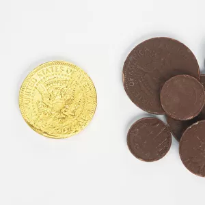 Chocolate coins, in and out of gold wrappers
