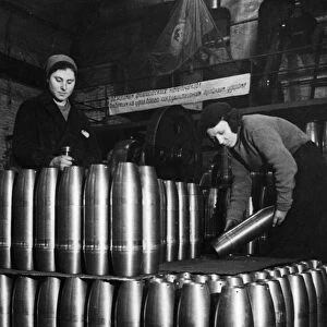 Civilian women involved in the production of artillery shells at a munitions factory in moscow during world war 2, march 1942