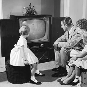 Family gathered around television