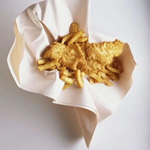 Fish and chips in paper wrapping