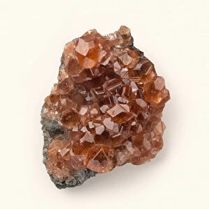 Grossular garnet crystals on rock surface, close-up