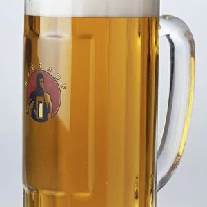 Half litre of frothy pale beer served in glass tankard