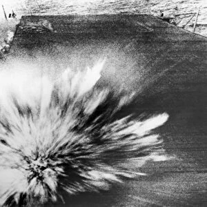 A Japanese bomb explodes on the flight deck of the USS Enterprise, killing the photographer, Phom 3 / c Robert Read, but the film survived