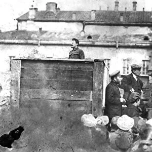 Leon trotsky addressing troops on their way to the polish front (civil war period), may 5th 1920, sverdlov square, moscow, on the stairs behind the speakers platform are lev kamenev (in peaked cap) and v, i, lenin