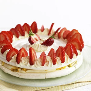 Mango and passion fruit meringue decorated with cream and strawberries