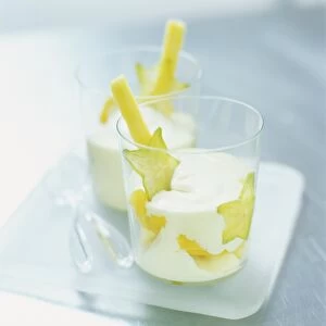 Pineapple zabaglione served with whipped cream and tropical fruit slices, close up