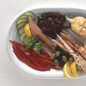 Plate of seafood and vegetables, including smoked eel, fish, crayfish, beetroot, peppers and Skordalia (garlic spread), a typical meze dish from Greece, view from above