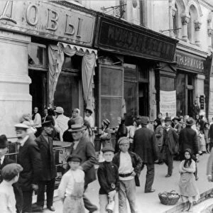 Russian street scene, February 1918: Women and children wait in a long line to buy milk