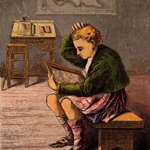 Scottish schoolboy dressed in a kilt and woollen threequarter hose (socks) puzzling