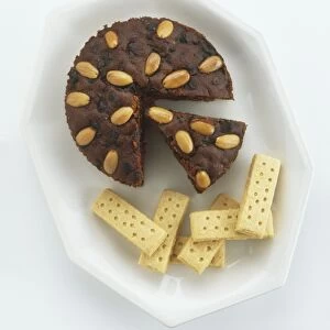 Shortbread biscuits and Dundee cake made from dried fruit and spices and topped with almonds, view from above