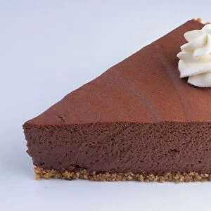 A slice of chocolate pie decorated with cream