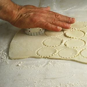 Stamping out rounds in the dough, using a pastry cutter