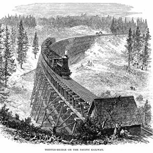 Union Pacific Railroad: Train crossing wooden trestle bridge carrying railroad across