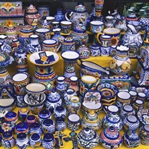 USA, Mexico, brightly coloured glazed ceramics for sale on market stall, high angle view