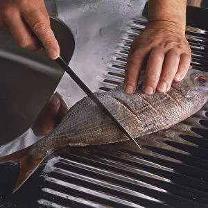 Use a sharp knife to slash the fish diagonally on each side