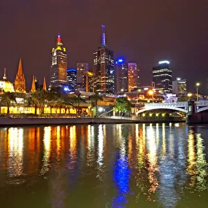 Australia, Melbourne, illuminated cityscape reflected in Yarra River
