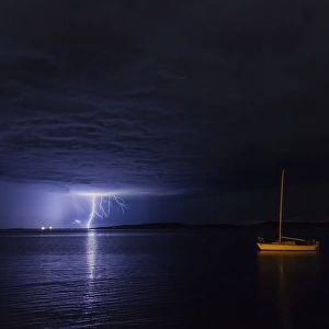 Lightning over moored yacht