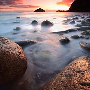 Rocks in ocean at sunrise
