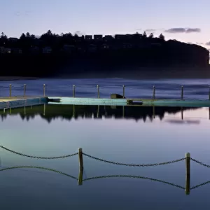 Sea Pool with chain fence reflecting in the still sea water Bilgola New South Wales Australia