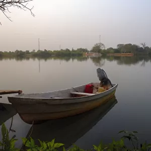 Small Fishing boat on banks of river Gambia in early morning before sunrise