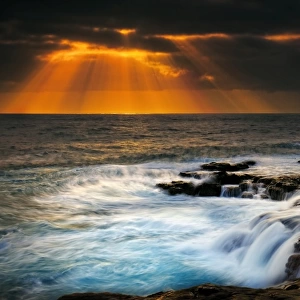 Sunbeams over stormy sea