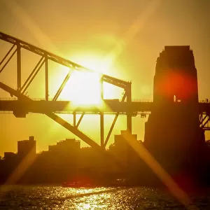 Sunburst through the Sydney Harbour Bridge at sunset