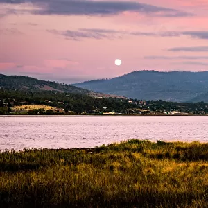 Sunset and moon rise over River Derwent. Huon valley, Hobart suburbs, Tasmania