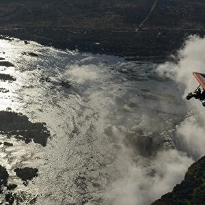 Aerial view of a micorlight (ultralight) flying over the Zambezi River and Victoria Falls. Livingstone. Zambia