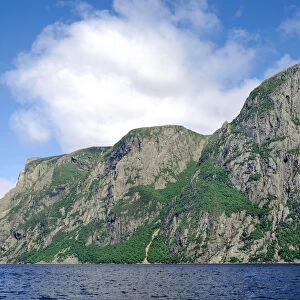 Billion year old rock of Long Range Mountains form steep cliffs above Western Brook Pond, Gros Morne National Park, Newfoundland, Canada