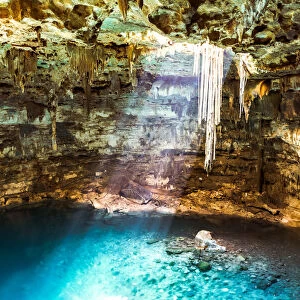 Blue Cenote with sunlight from the top, Yucatan, Mexico