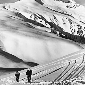 Couple cross-country skiing in mountains