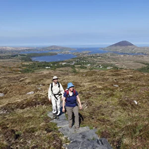 Hikers climbing to Diamond Hill, Connemara National Park, County Galway, Republic of Ireland, Europe
