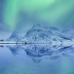Lofoten Islands, Norway. Aurora Borealis over the lake and landscape mirroring