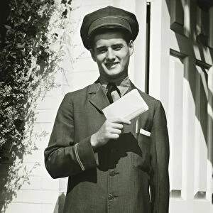 Mailman holding blank form outdoors, (B&W), portrait