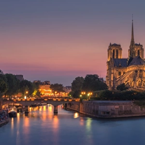 Notre dame at night with city light