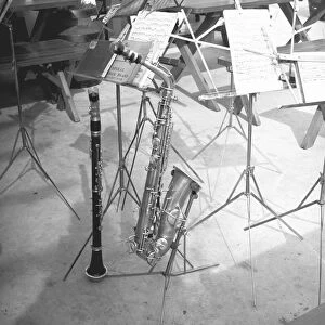 Oboe and saxophone with music sheets, (B&W)